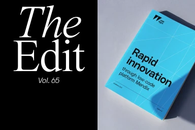 Split view with black panel displaying white serif text on left and blue bound publication resting on white surface on right.