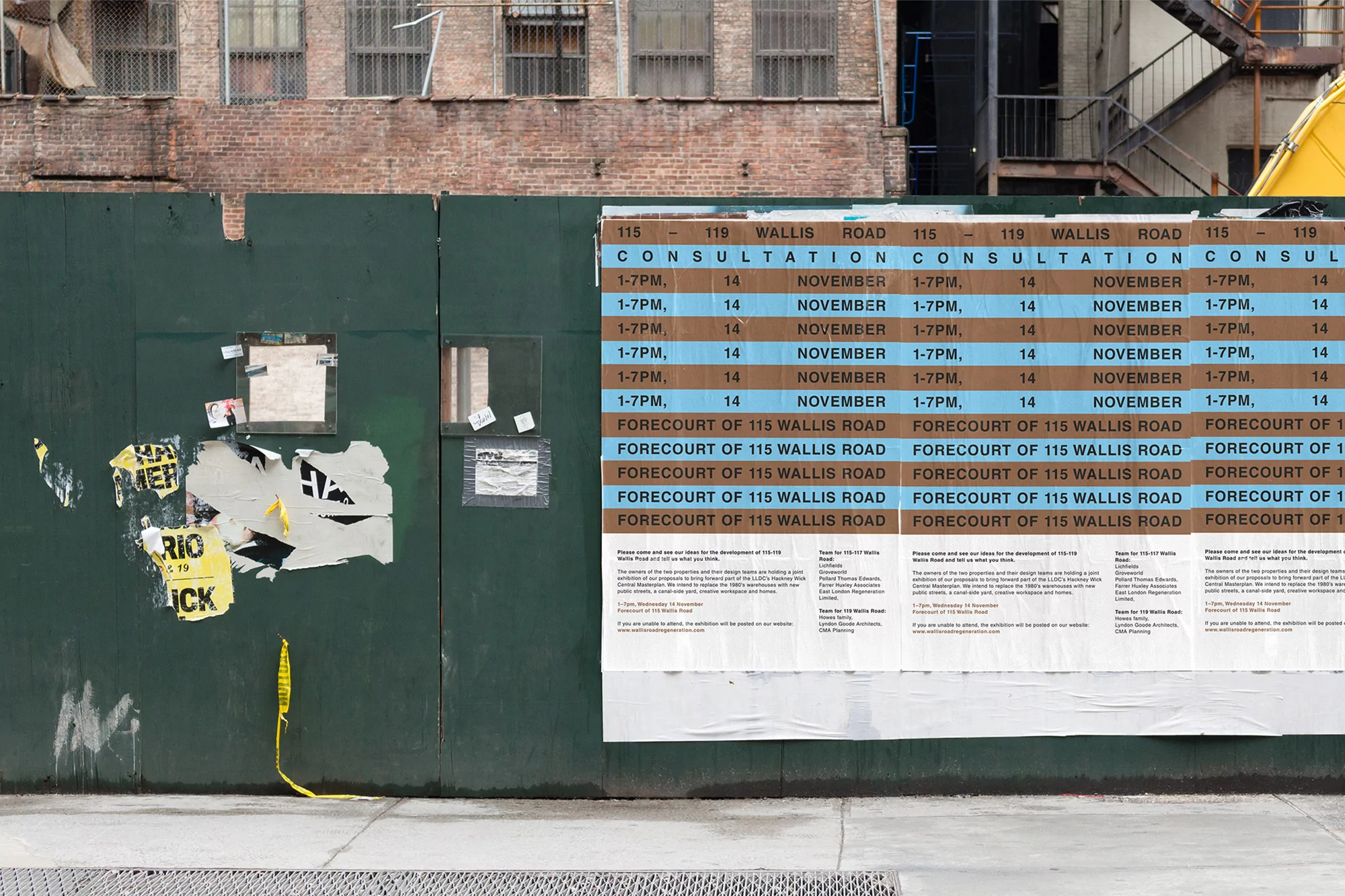 An outdoor shot shows a green construction fence covered in consultation notices in an urban environment, with a brick building in the background.