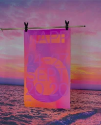 Hanging poster with pink and orange gradient typography suspended by clips against a sunset seascape backdrop