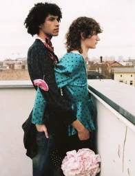 Two male models posing on a rooftop with city background for a Dazed Magazine editorial