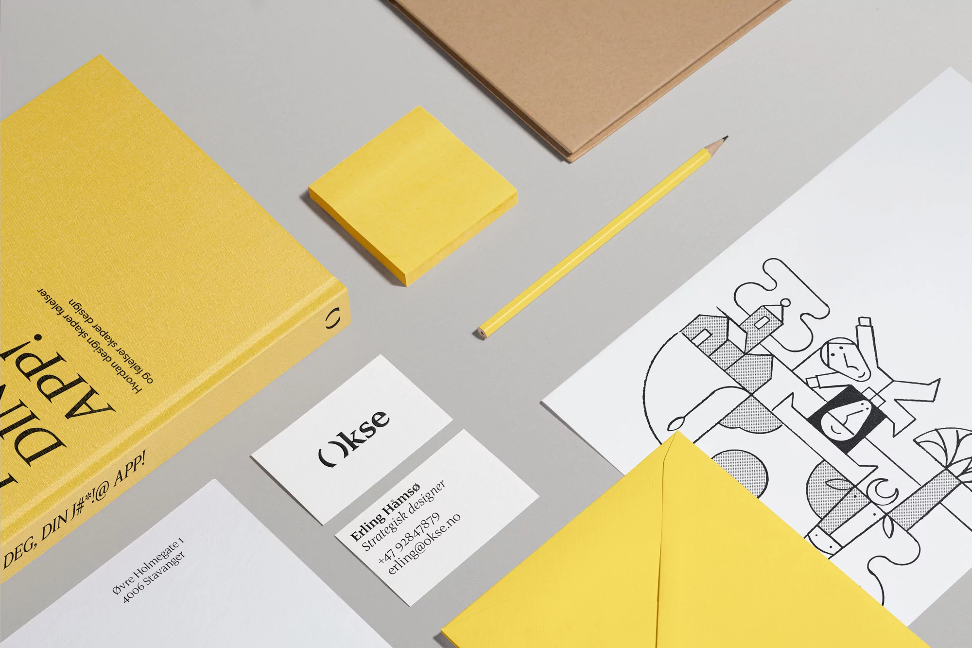 Graphic design concept with yellow book, sticky note, pencil, white paper with a graphic illustration, business cards, and yellow envelope.
