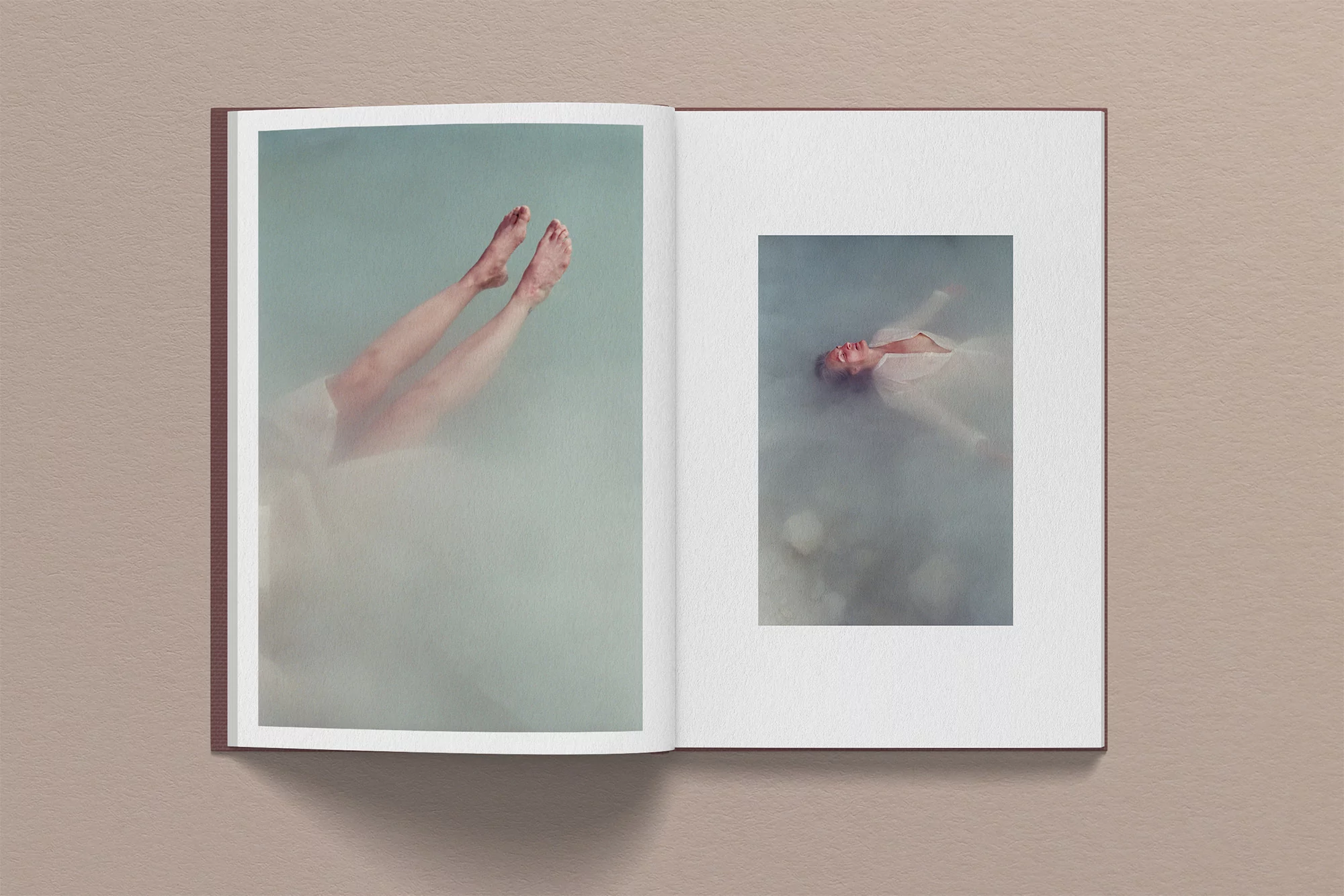 Open book displays two photos: one showing human legs in water and another showing a woman floating in water, creating a serene scene.
