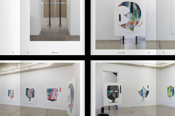 Art exhibition featuring abstract face paintings on white canvases with minimal metal stands in a bright, white-walled gallery space.
