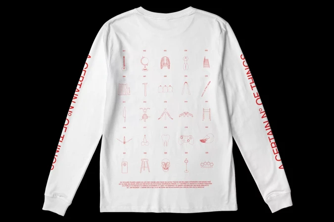 White long-sleeved shirt with red printed graphics showing line drawings of objects and the text 'A CERTAIN N° OF THINGS'.