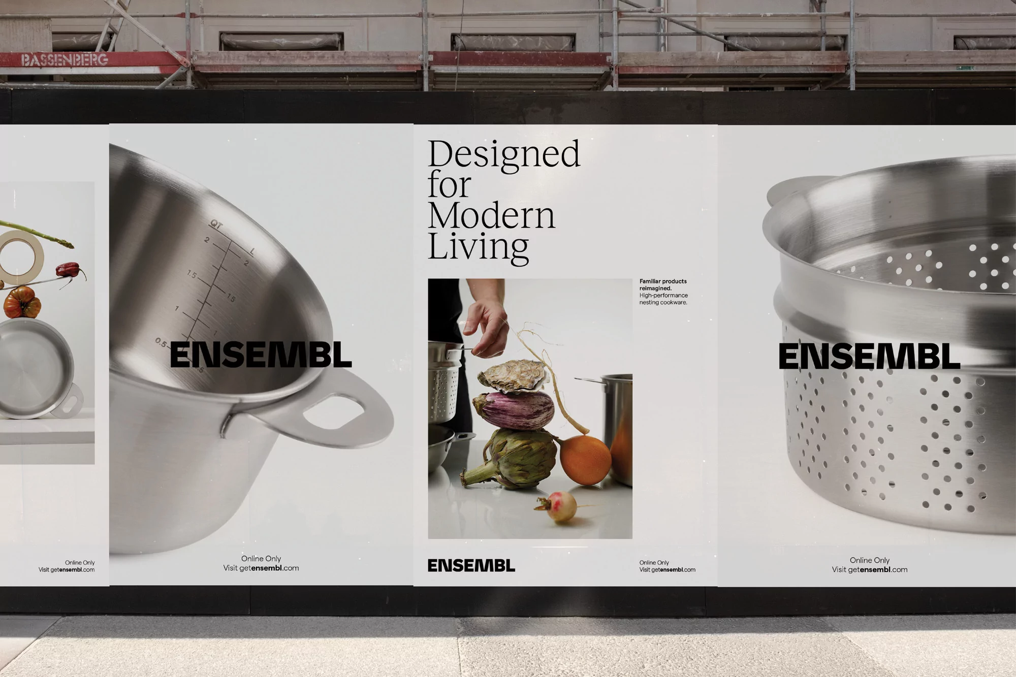 Large posters display Ensembl cookware, including pots, colanders, and food ingredients against a neutral background on a city street.