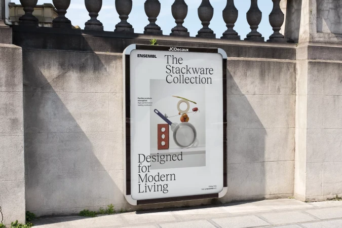 Outdoor advertising billboard showcasing 'The Stackware Collection' on a city street with natural light and stone architecture backdrop.