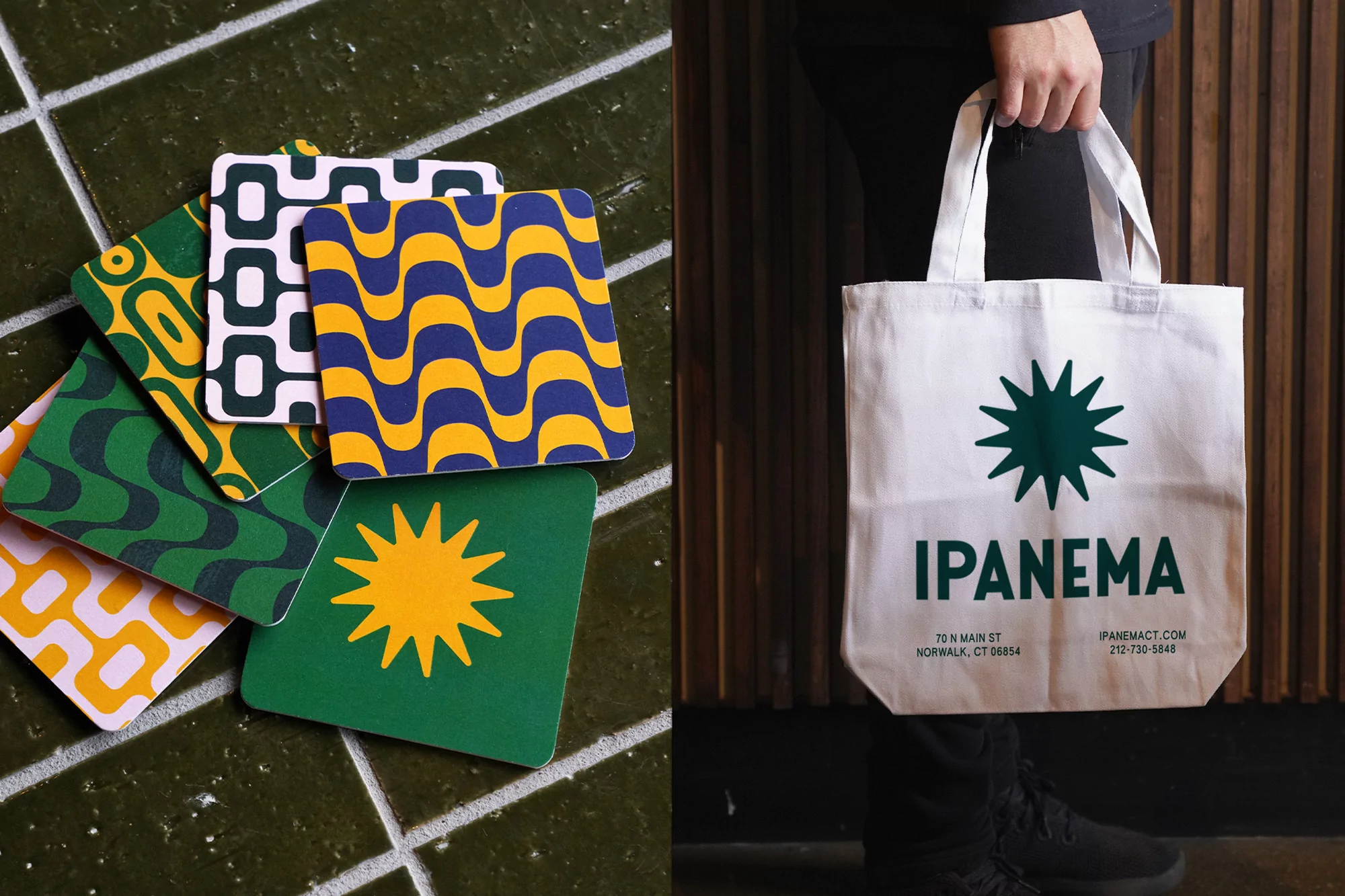 Various patterned coasters stacked next to a tote bag held by a person wearing black pants against a wood-paneled wall.
