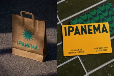 Kraft paper shopping bag and yellow business card with green Ipanema brand typography on tiled surfaces.