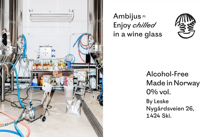 Stainless steel tanks and bottling equipment inside a beverage production facility, featuring bottles and containers on shelving.