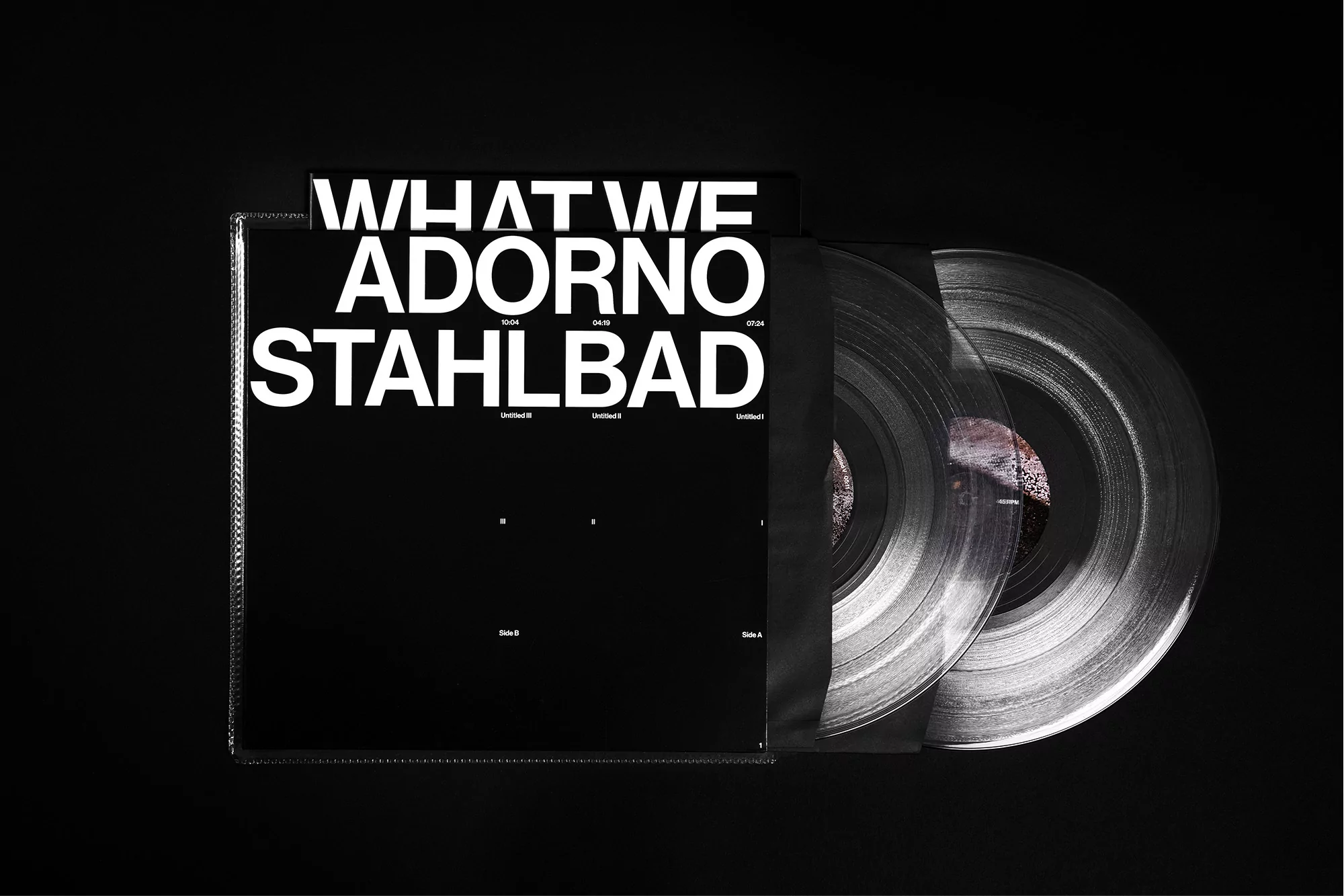 Vinyl record album featuring graphic design on black background in medium studio shot with modern fonts and transparent vinyl records.