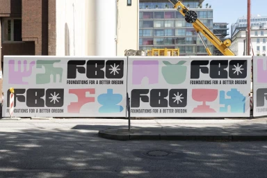 Construction hoarding banner with bold typography and pastel graphics featuring Playtype brand identity