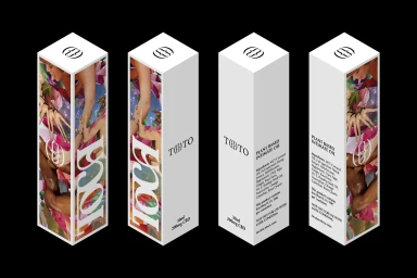 Four isometric white packaging boxes for TOCA brand identity showing botanical collage artwork and typography against black