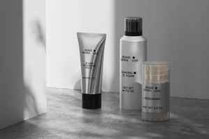 Three Bravo Sierra grooming products including hair paste, shaving foam, and deodorant arranged on a textured concrete surface.