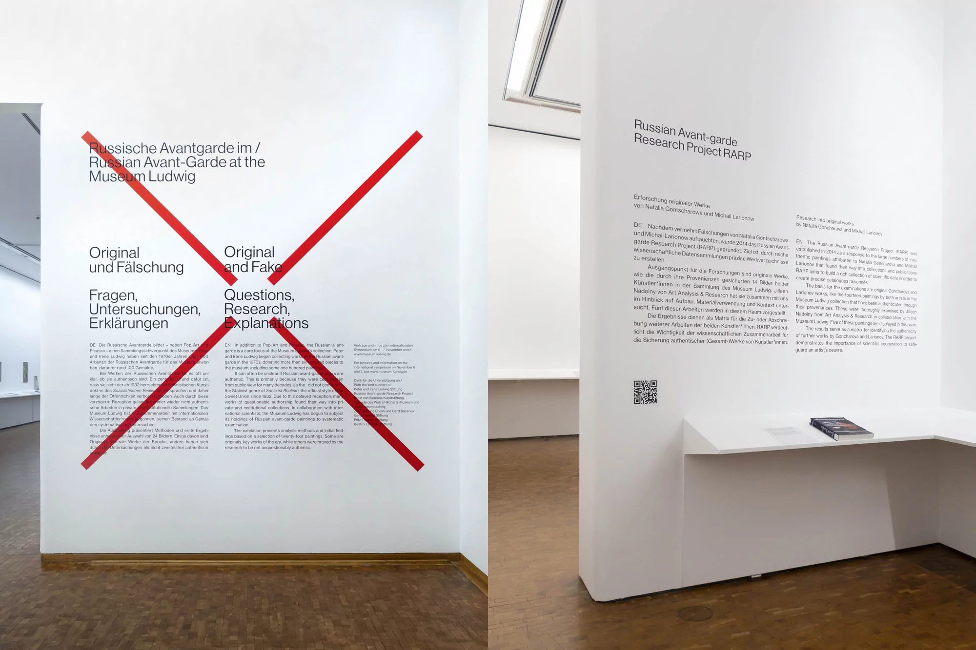 View of an art installation featuring text in German and English crossed out with a large red X at Museum Ludwig, Cologne, Germany.