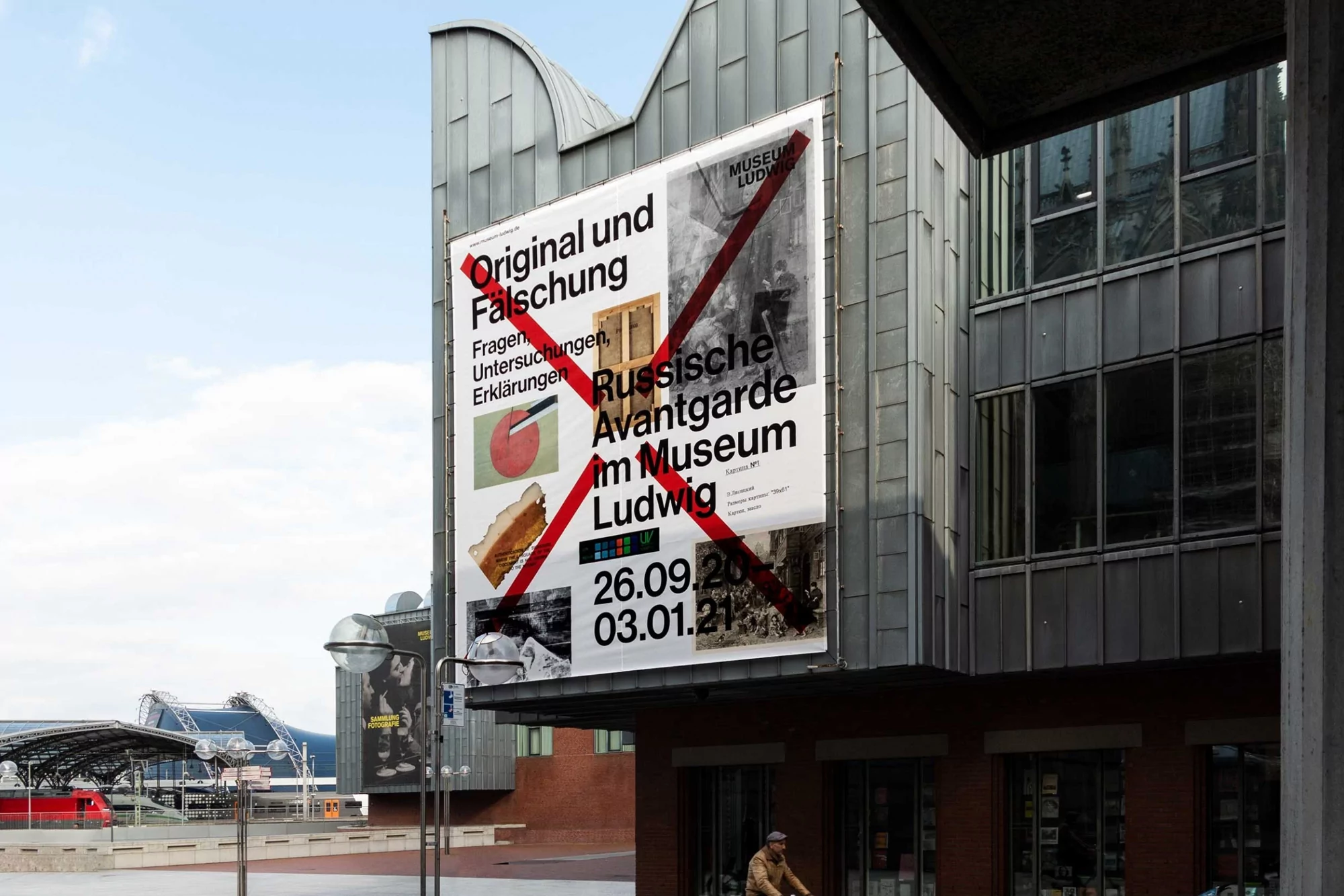 Museum Ludwig exhibition poster, 'Original und Falschung', featuring Russian Avantgarde art, on building exterior in Cologne, Germany.