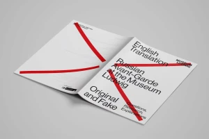 An open brochure for Museum Ludwig on a grey background with striking red diagonal graphic lines crossing the pages.
