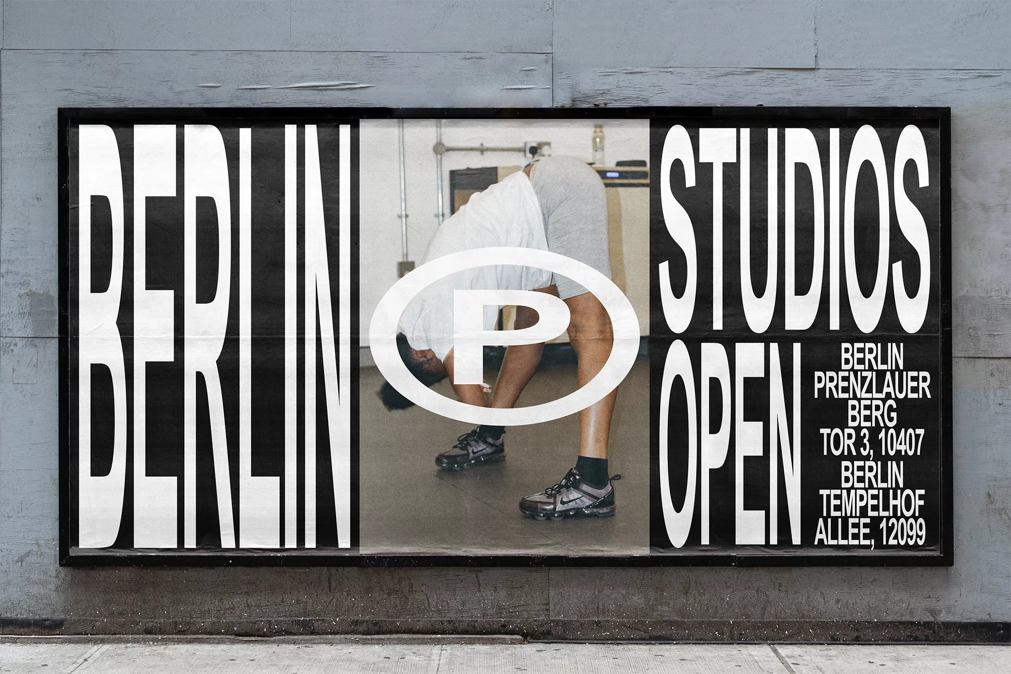 A poster with the words BERLIN STUDIOS OPEN. An adult does stretching exercise in front of a concrete wall.