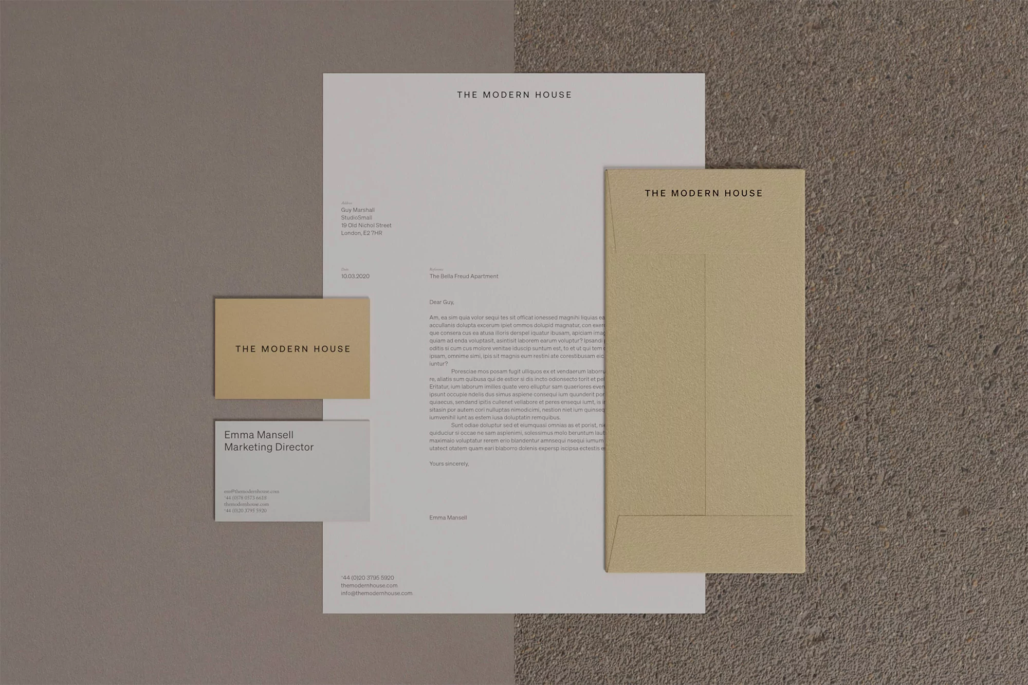 Stationery mockup featuring letterhead, envelope, business cards, and textured grey background with the brand name 'The Modern House'.