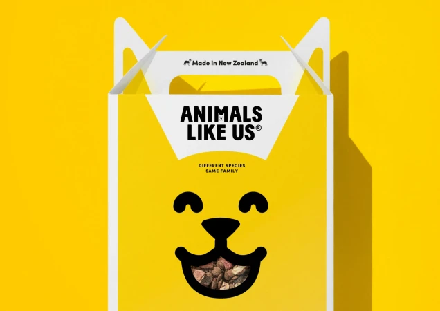 A yellow box for Animals Like Us brand with a cat face and tagline that reads: Different Species, Same Family, New Zealand made