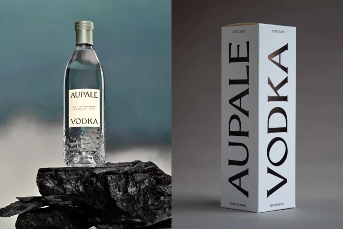 Bottle of Aupale Vodka displayed on black stone next to a white product box. Minimalist presentation with a clean, modern aesthetic.