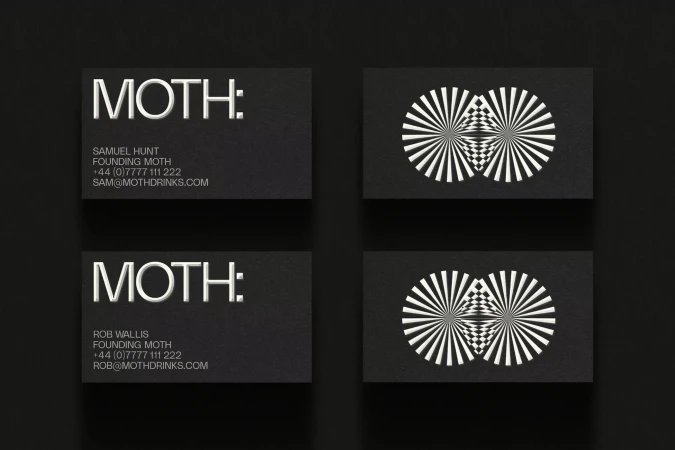 Two sets of black business cards featuring the word 'Moth' and a geometric pattern; minimalist design on a dark surface.