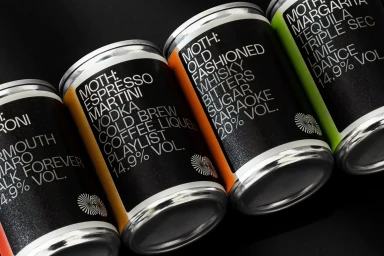 Close-up angled shot of four MOTH cocktail cans featuring bold typography against a dark background