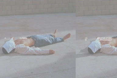 Person lying flat on a concrete ground outdoors wearing jeans and a white shirt with head covered