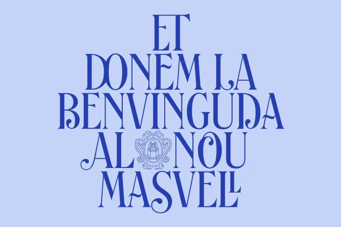 Typographic art featuring a phrase in Catalan on a light blue background, including an ornate symbol in the center.