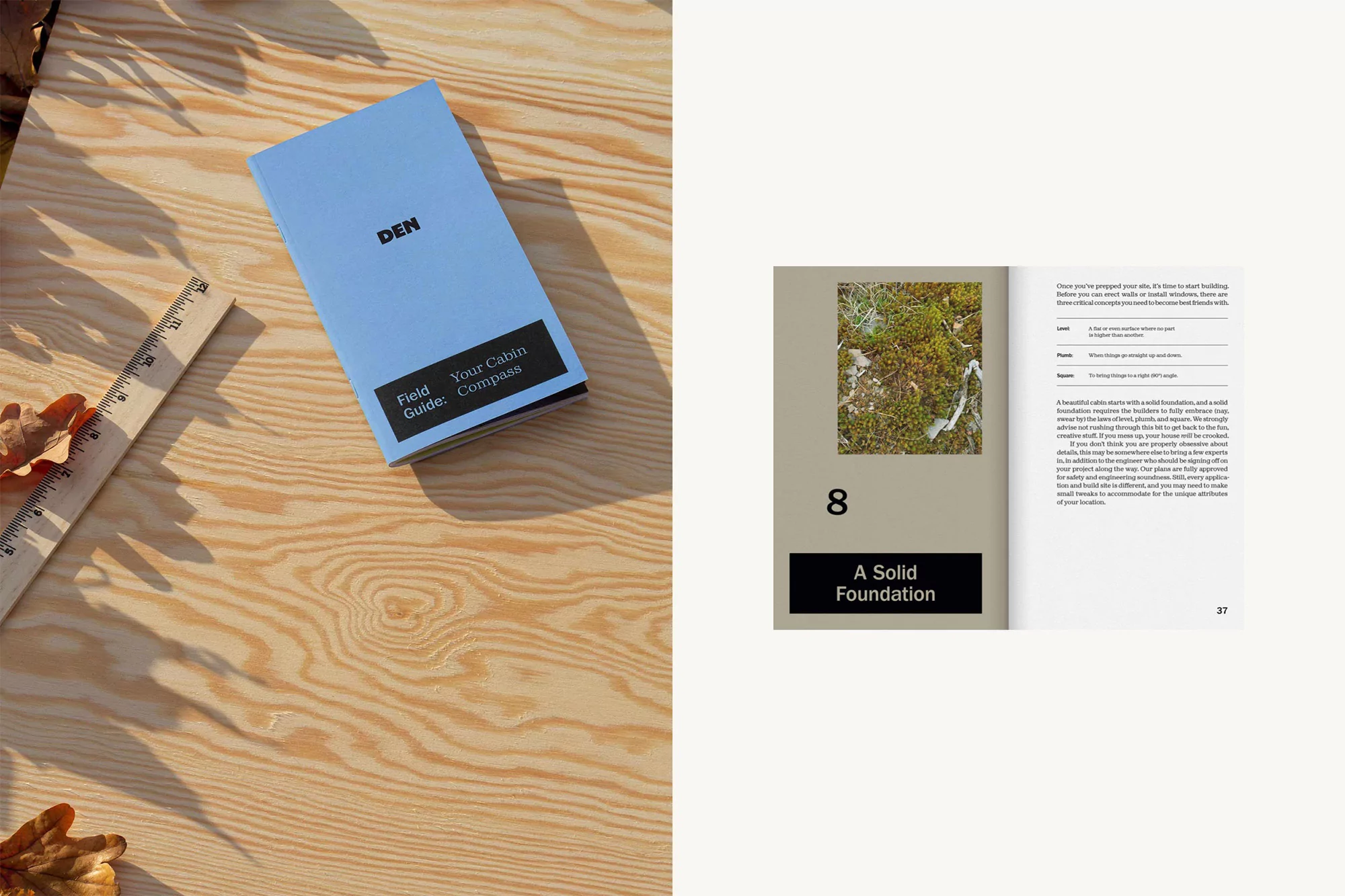 Overhead shot: 'DEN Field Guide Your Cabin Compass' book next to a ruler and leaves on woodgrain surface with an open book page.