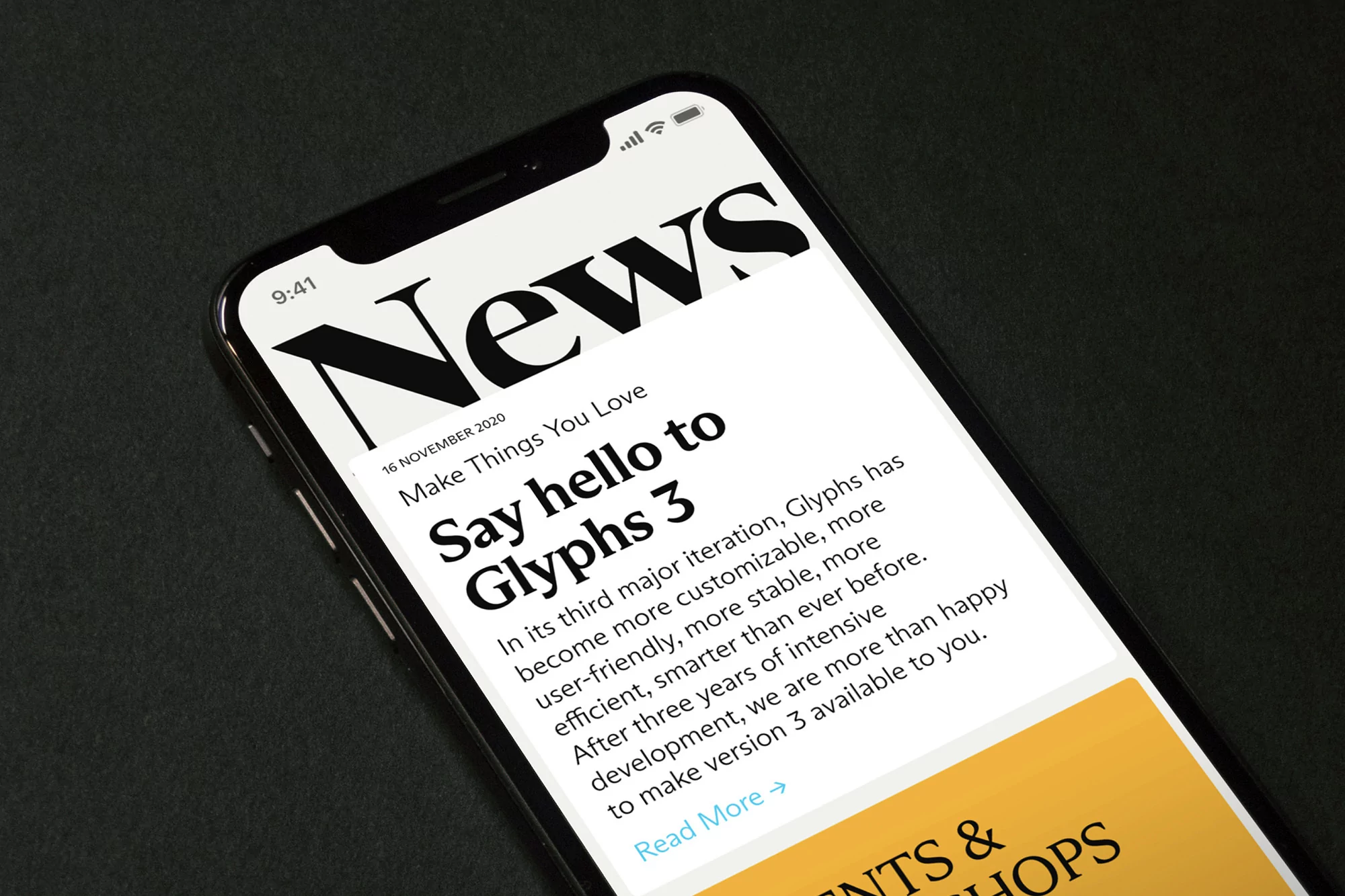Smartphone displays a news article about Glyphs 3 against a dark background. The screen features legible typography and interface elements.