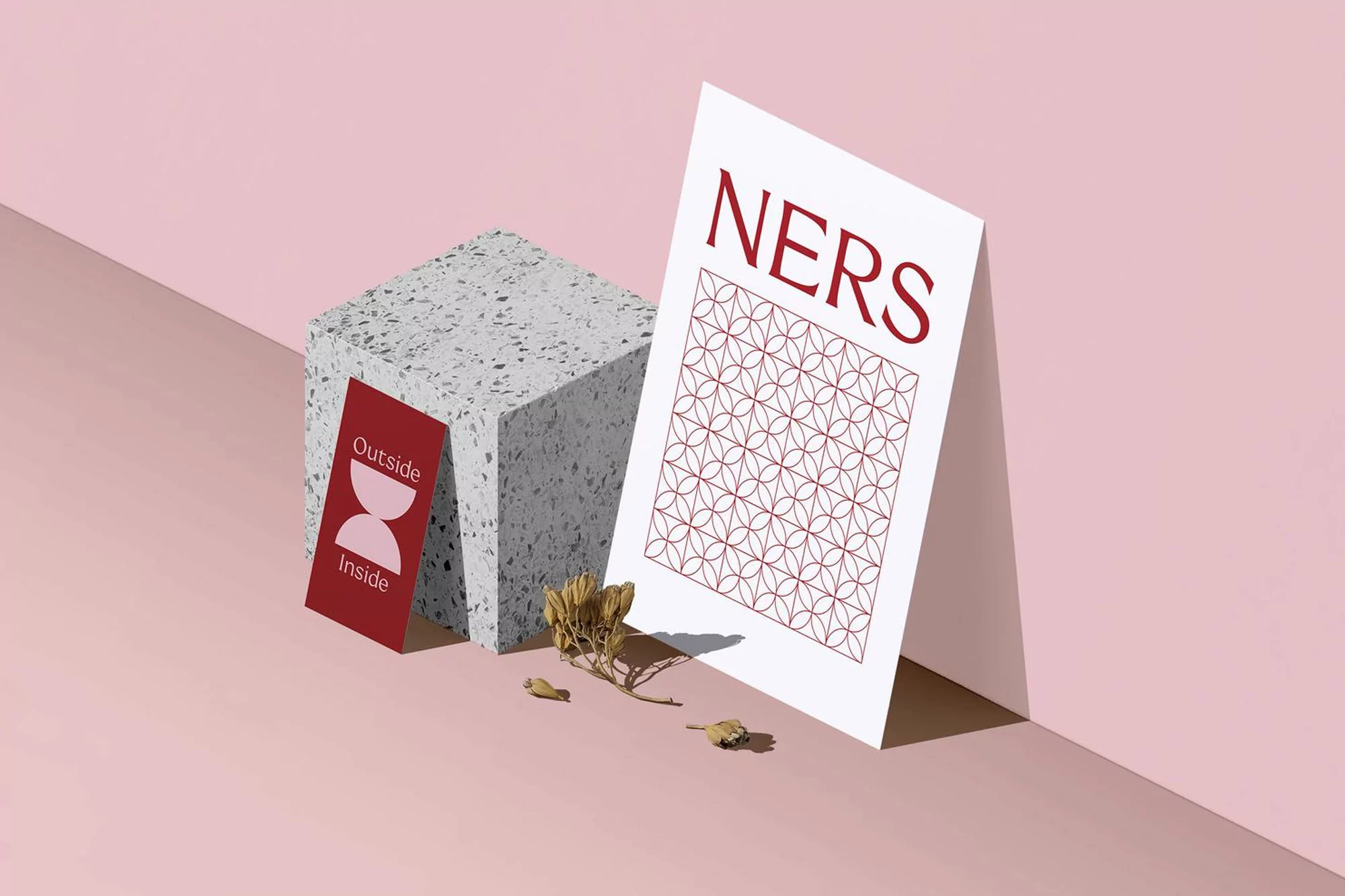 Geometric paper art on a pink background featuring paper blocks, graphic designs, and muted neutral colors in a minimalist composition.