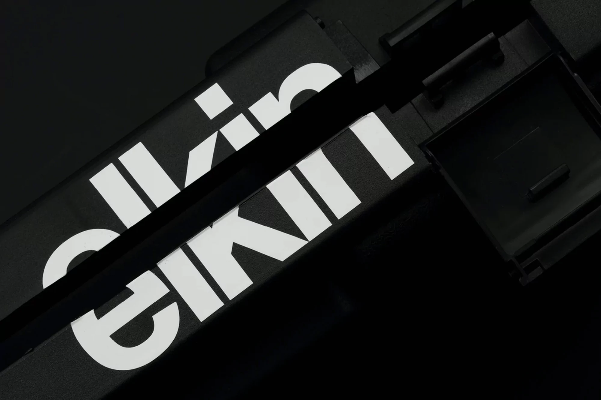Close-up photograph of two black boxes with white sans-serif text on them, creating a minimalist and monochromatic visual.