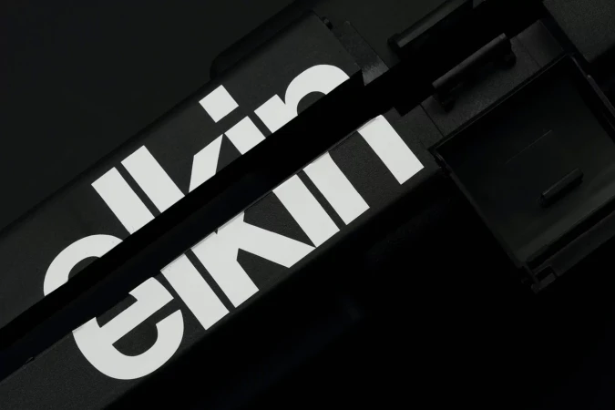 Close-up photograph of two black boxes with white sans-serif text on them, creating a minimalist and monochromatic visual.