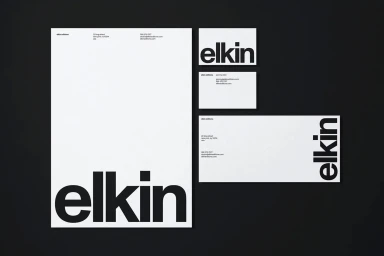 Elkin Editions brand identity stationery set featuring letterhead, business cards, and envelope on dark background