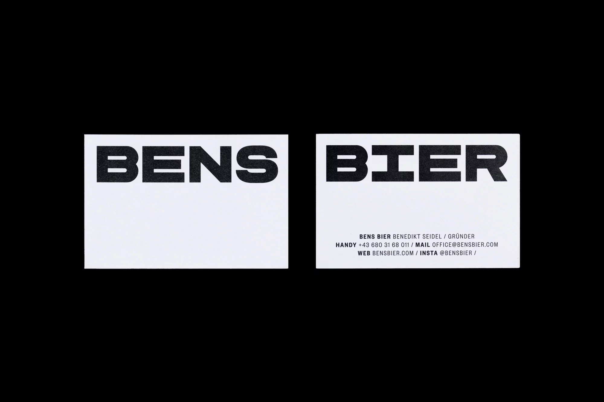 Two business cards featuring 'Bens Bier' branding in black text on a white card, set against a solid black background.