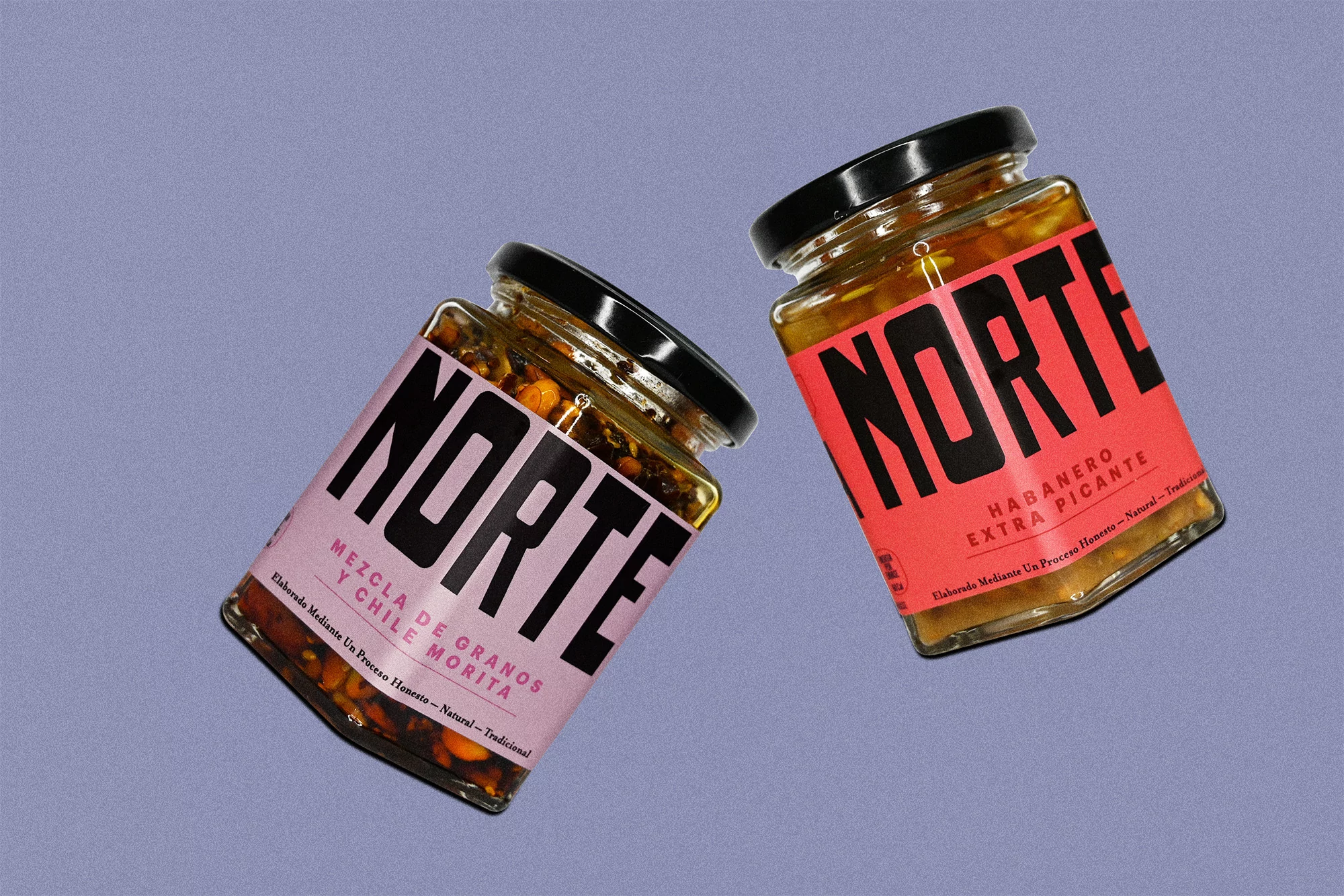 Two jars of 'Norte' brand hot sauce, one habanero, one chile morita, angled on a light blue background, product photography.