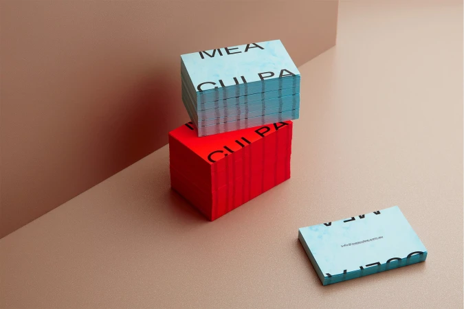 Stacks of vibrant business cards in red and light blue, conveying modern design and professional networking on a neutral background.