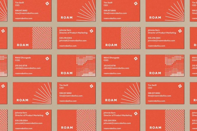 Multiple orange business cards arranged in a grid pattern, each featuring company and contact details with geometric graphic elements.