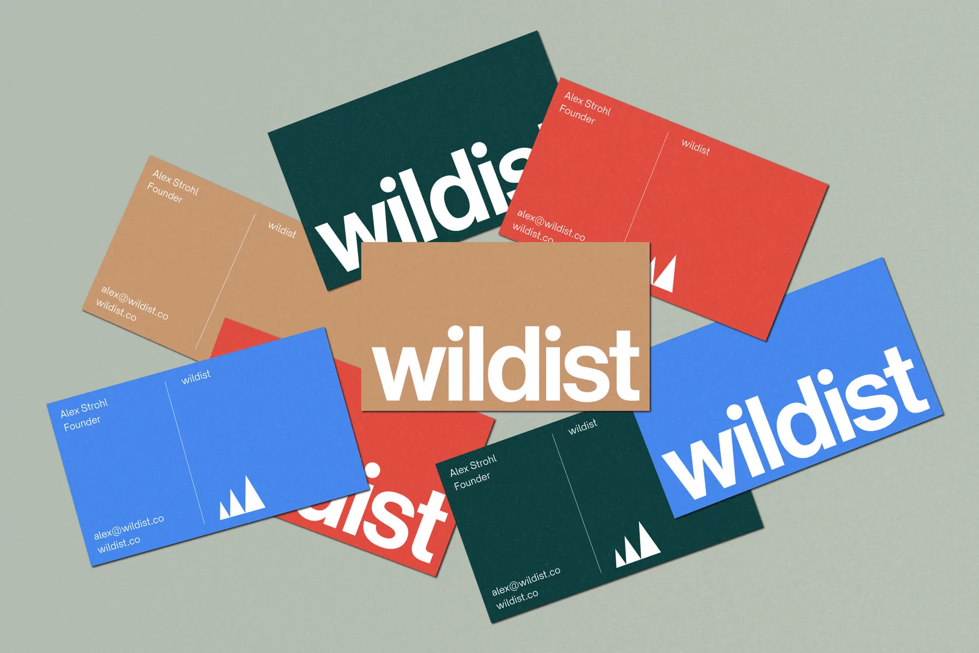 Multiple colorful business cards with the word 'wildist' and contact information arranged on a light grey surface in a pattern.