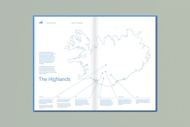 Open spread of a travel guide featuring a blue outlined map of Iceland with pointer lines and descriptive text columns on a neutral gray surface.