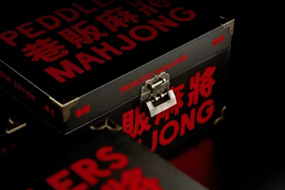 Black box with red typography and metal latch featuring Peddlers Gin Co. branding