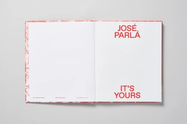 Open hardcover book with red typography on the right page reading Jose Parla It Is Yours against a plain white background.