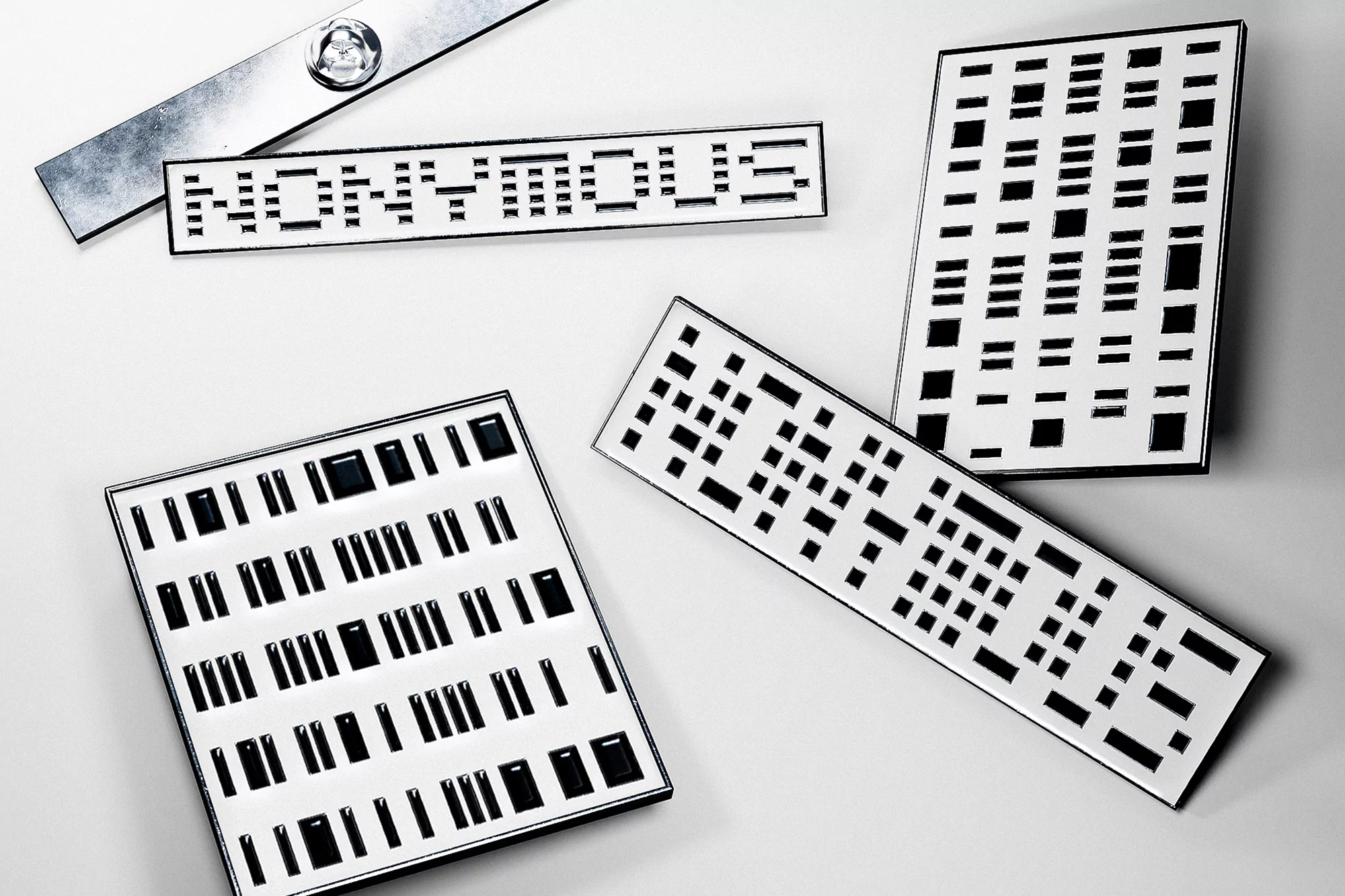 Graphic artwork of rectangular blocks arranged in patterns with the word 'NONNYMOUS' spelled out in a minimalist pixelated font.
