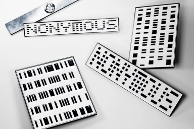 Monochrome flat lay displaying black and white branded signage and geometric barcode-style design plates on a plain background