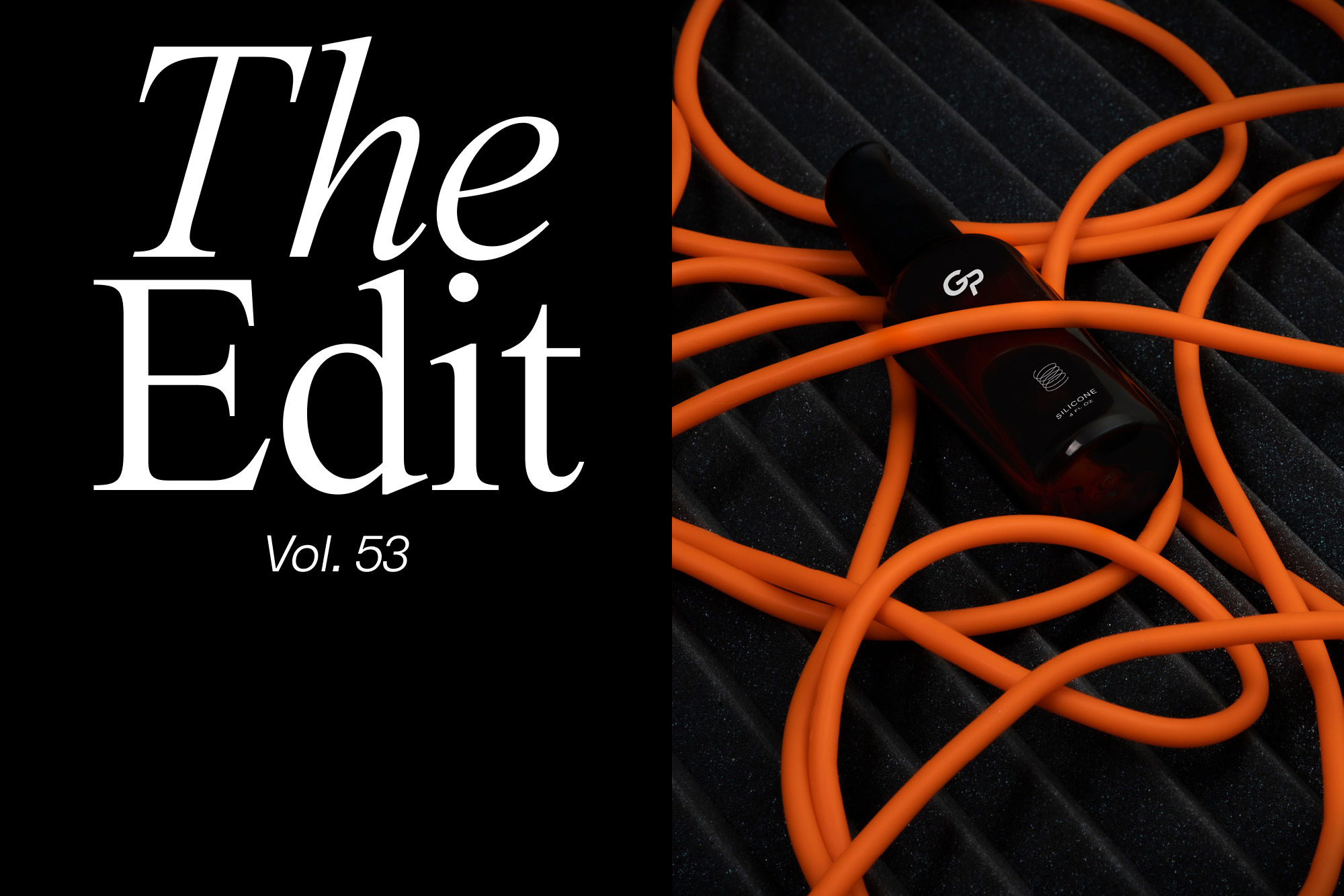 A cosmetic bottle on a black ridged surface with bright orange cords, next to white text that reads 'The Edit Vol. 53'.