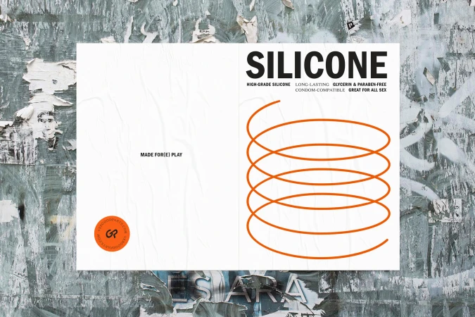 Advertisement featuring the word 'Silicone' in bold, next to a coil illustration, placed on a textured concrete wall with ripped posters.