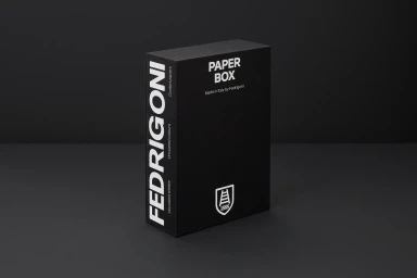 Black rectangular paper box with white typography standing upright on a dark grey surface