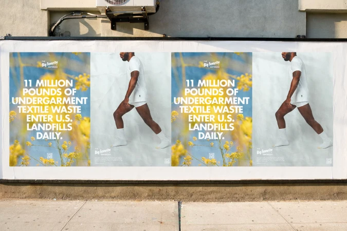 Outdoor advertisement featuring a man in white undergarments next to text promoting sustainable textile practices and The Big Favorite brand.