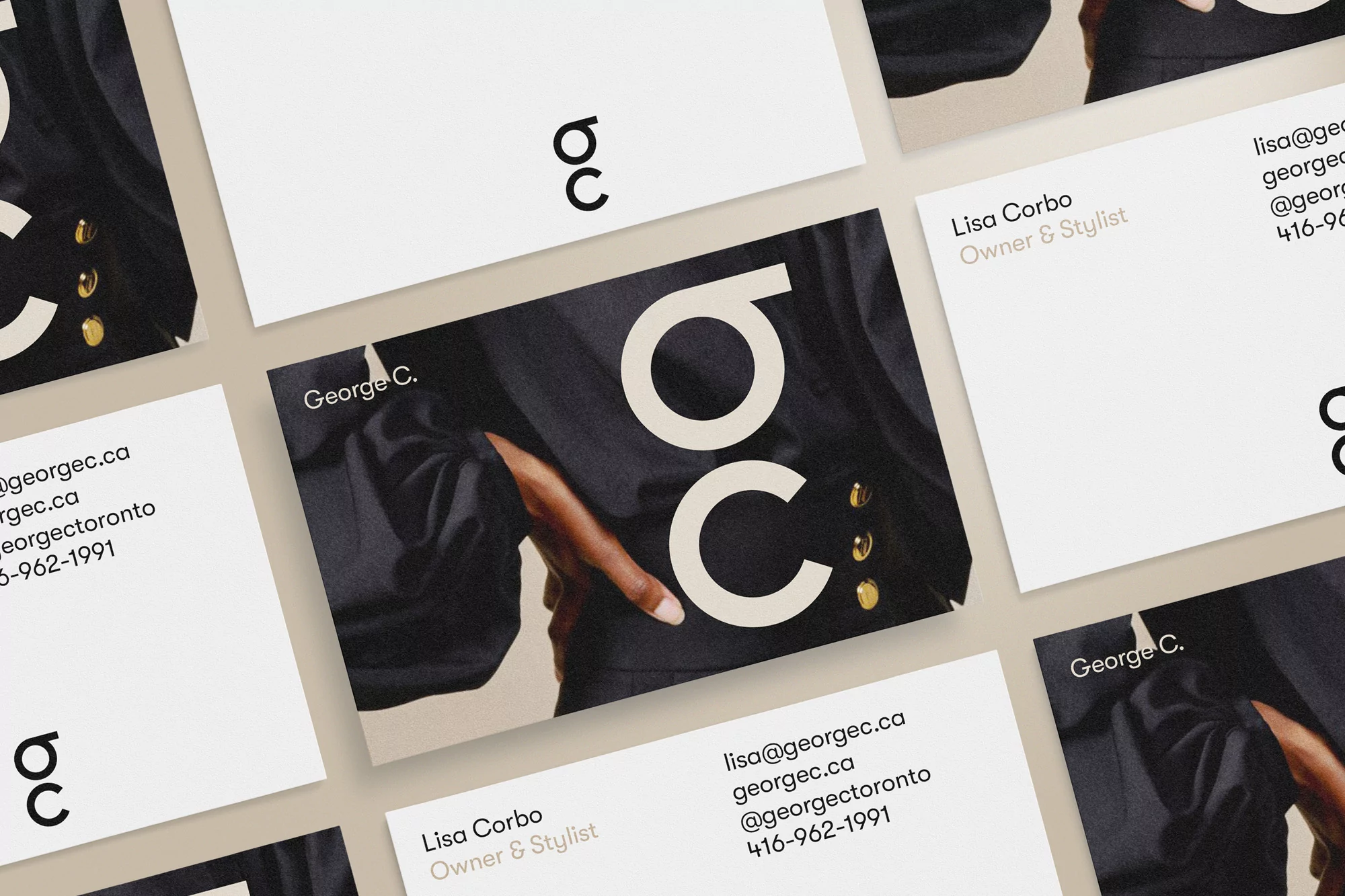 Close-up shot of business cards arranged with brand logos, contact details, and black and white business attire for professional services.
