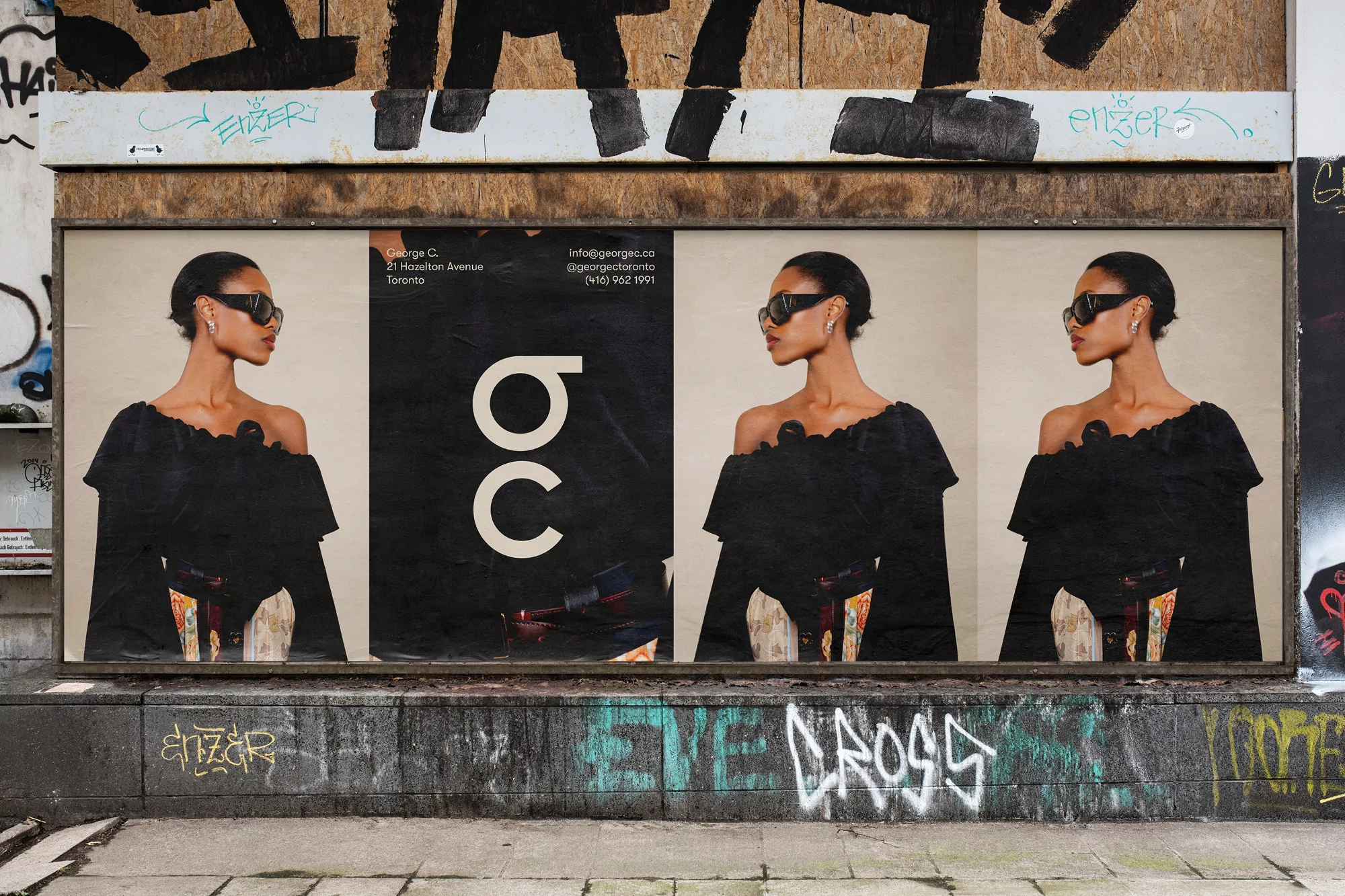 Outdoor poster featuring a woman with sunglasses and a black dress, set against an urban backdrop with graffiti and architectural elements.